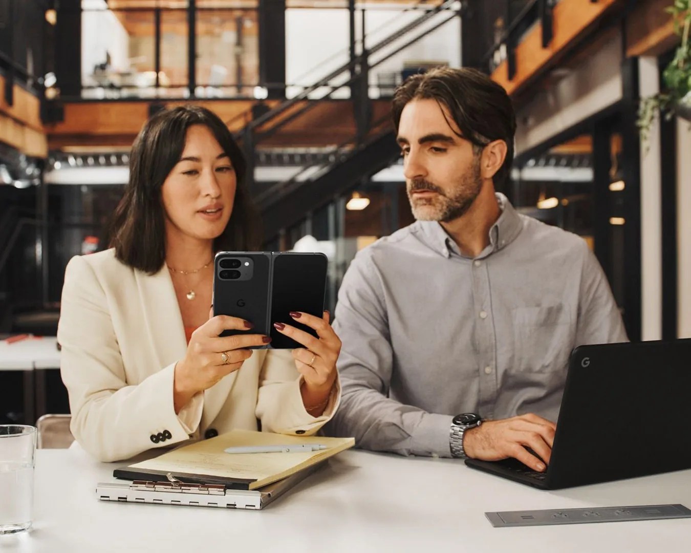 woman showing man her Google Pixel Fold Pro