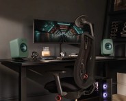 two green KEF LSX II LT on desk with computer set up