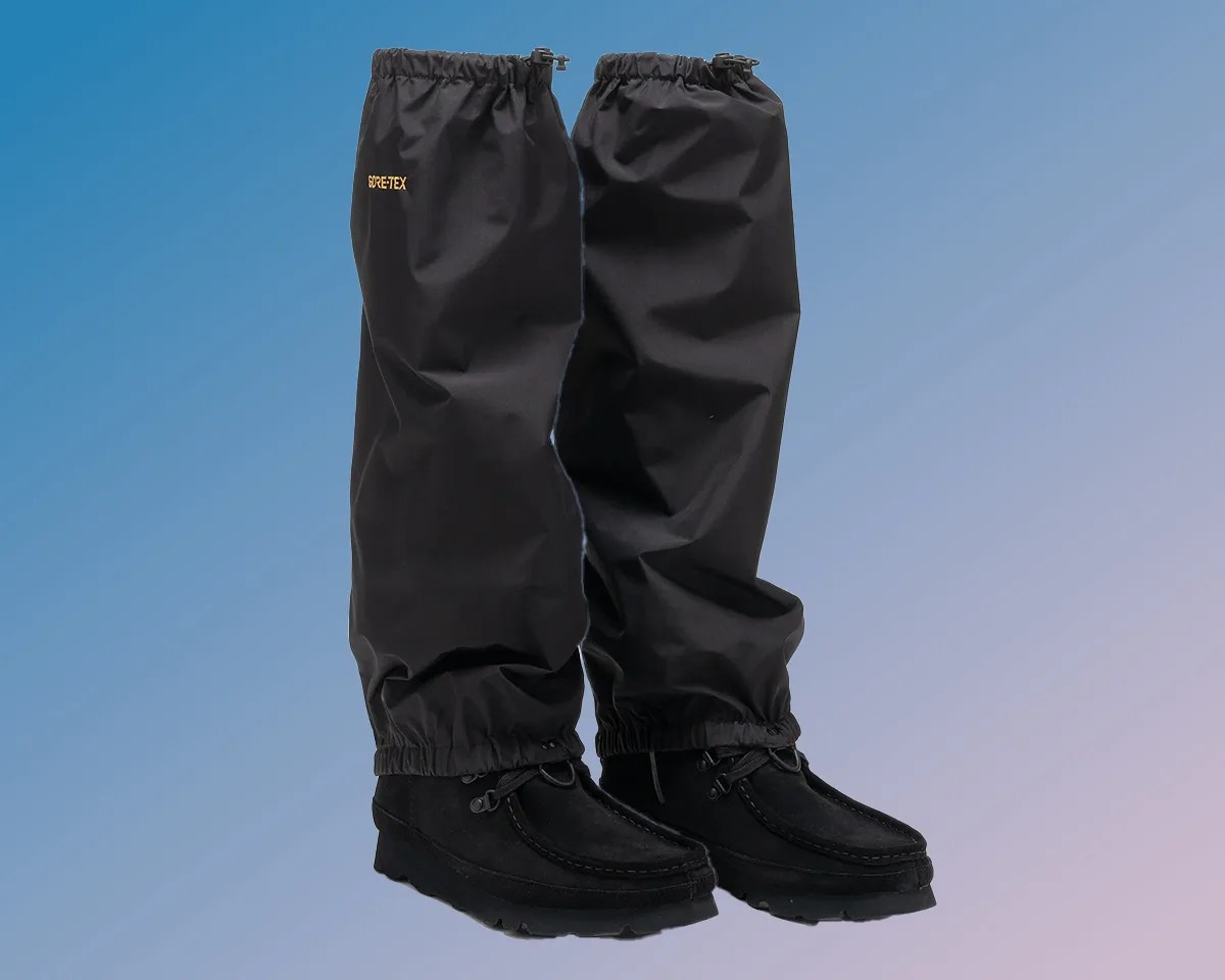 Clarks x Daiwa Anglers Walabee GTX SPs with gaiters on blue-purple gradient background