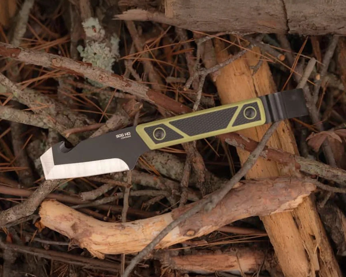 SOG Compound Tac Pry on pile of sticks and logs