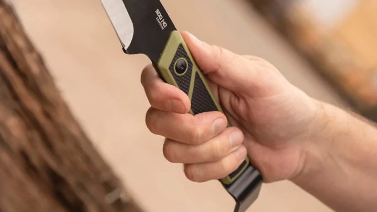 A closeup of a hand holding the SOG Compound Tac Pry