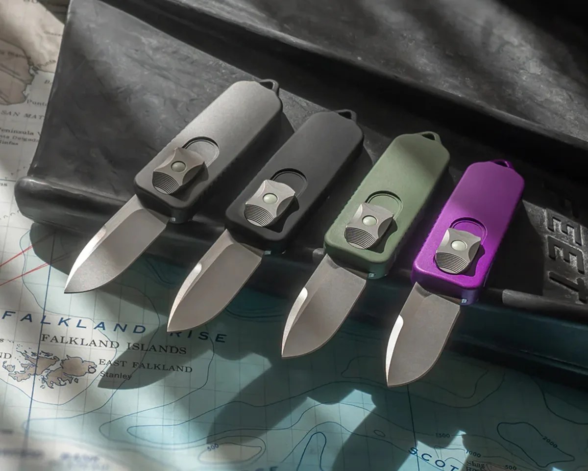Terrain 365 x Prometheus Design Werx CAS OTF knives laying on a swim fin atop a topographical map