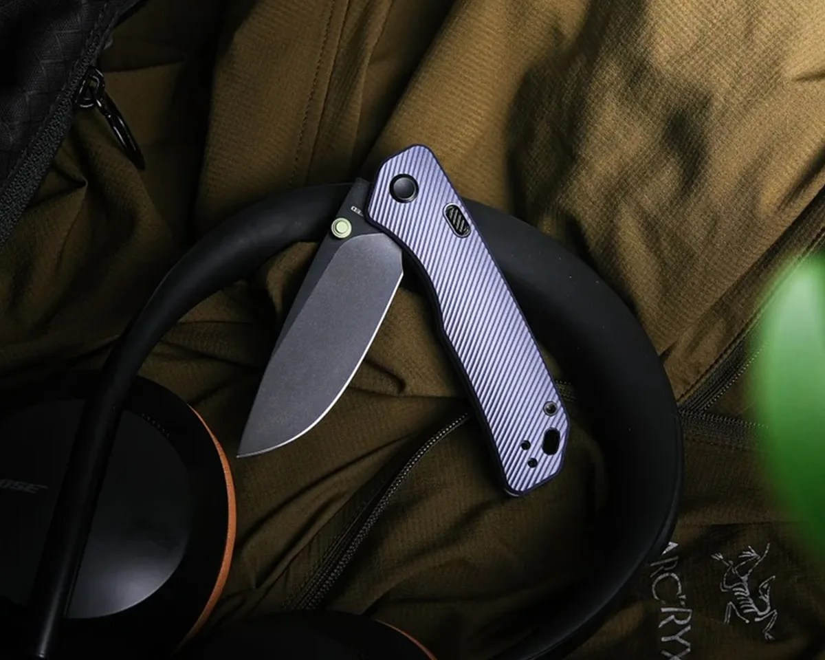 Vosteed Marten knife laying on Arc'teryx jacket and headphones