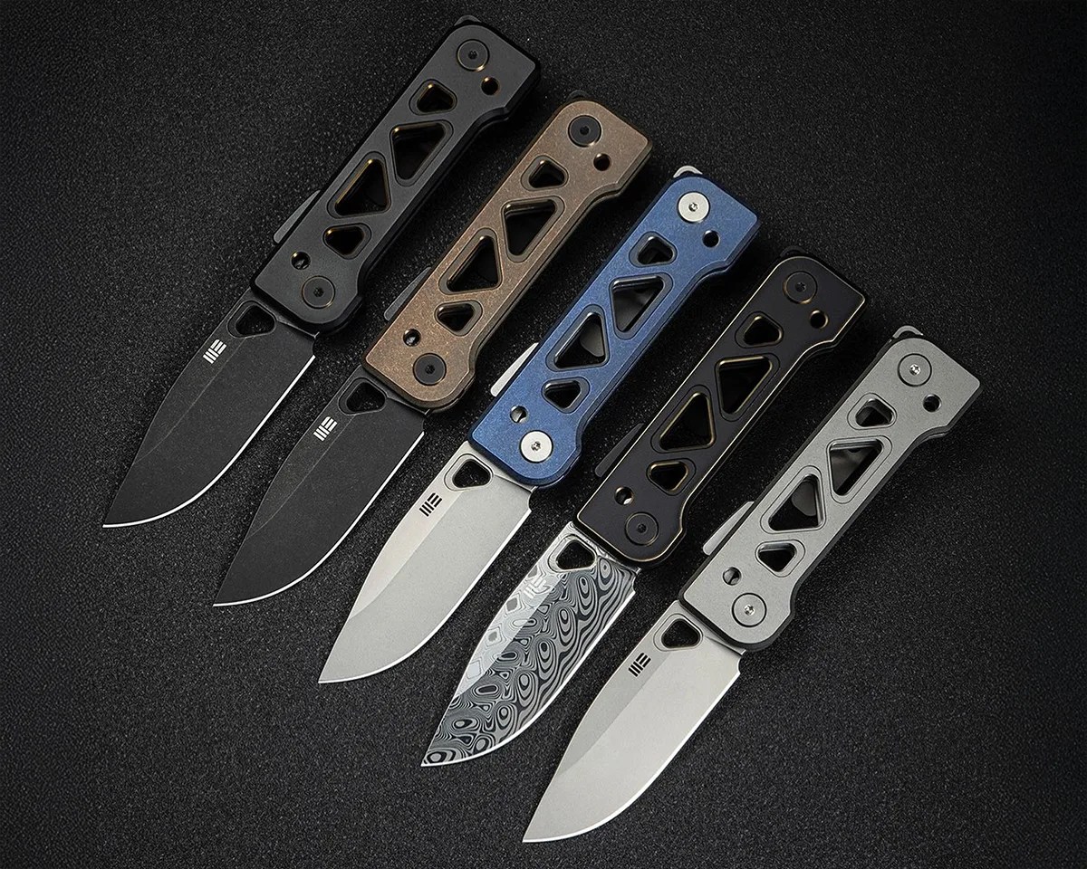Five We Knife Tyro knives on black background