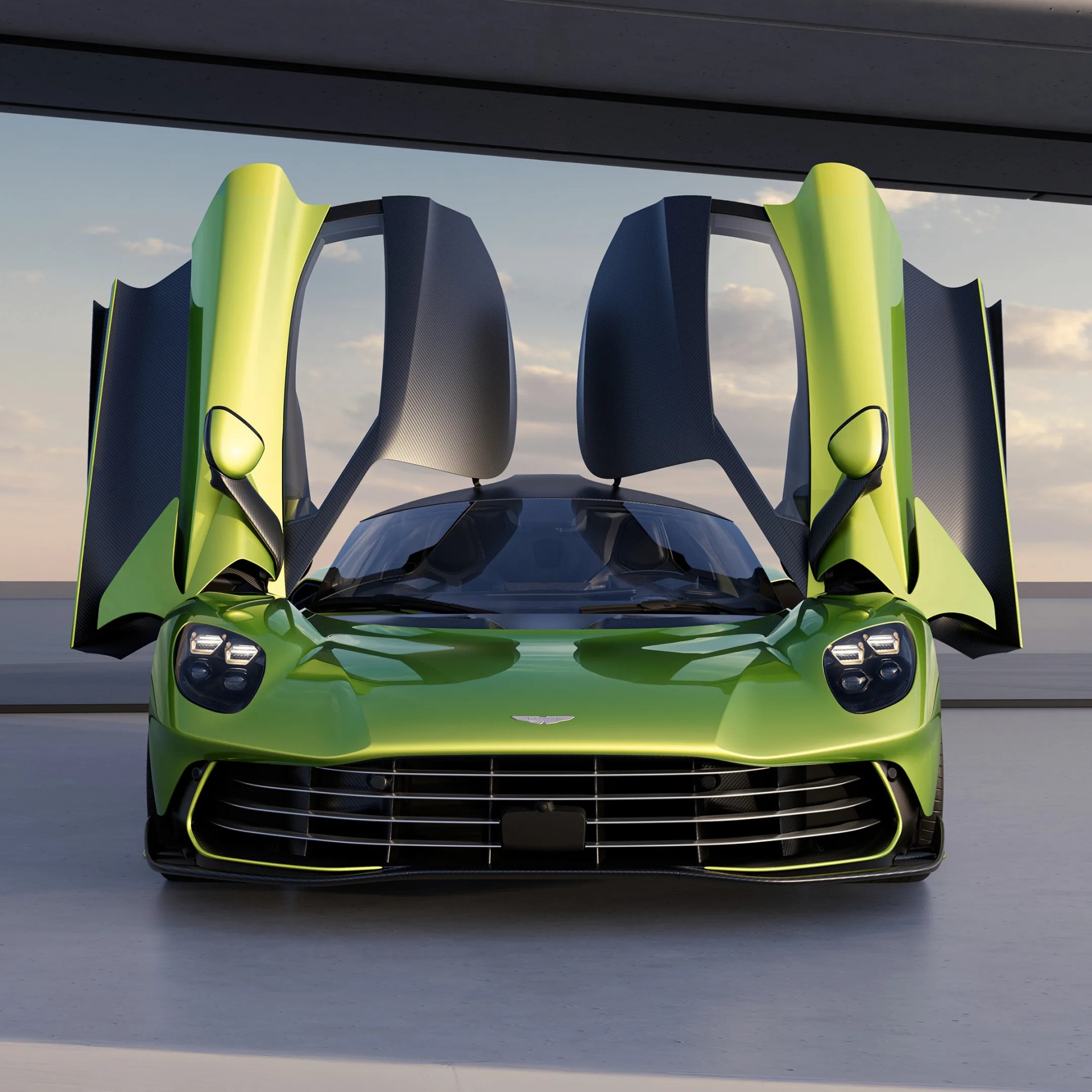an aston martin hypercar seen head on with its butterfly doors open