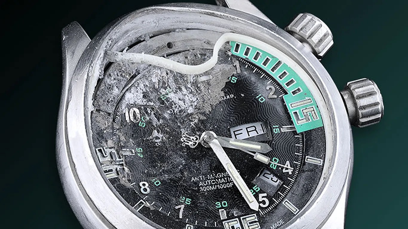 a ball dive watch that has been damaged by a bullet