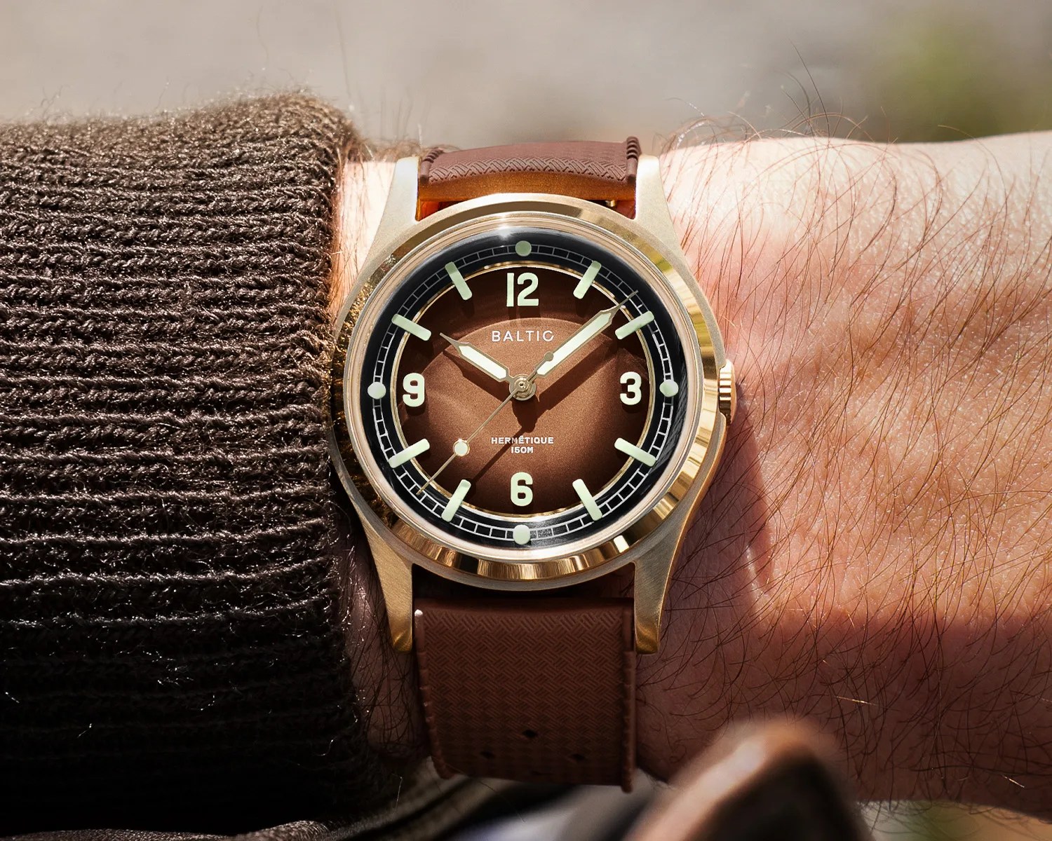 a bronze baltic field watch on a mans wrist
