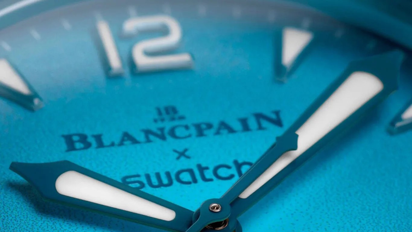 a closeup of a blue blancpain x swatch dive watch dial