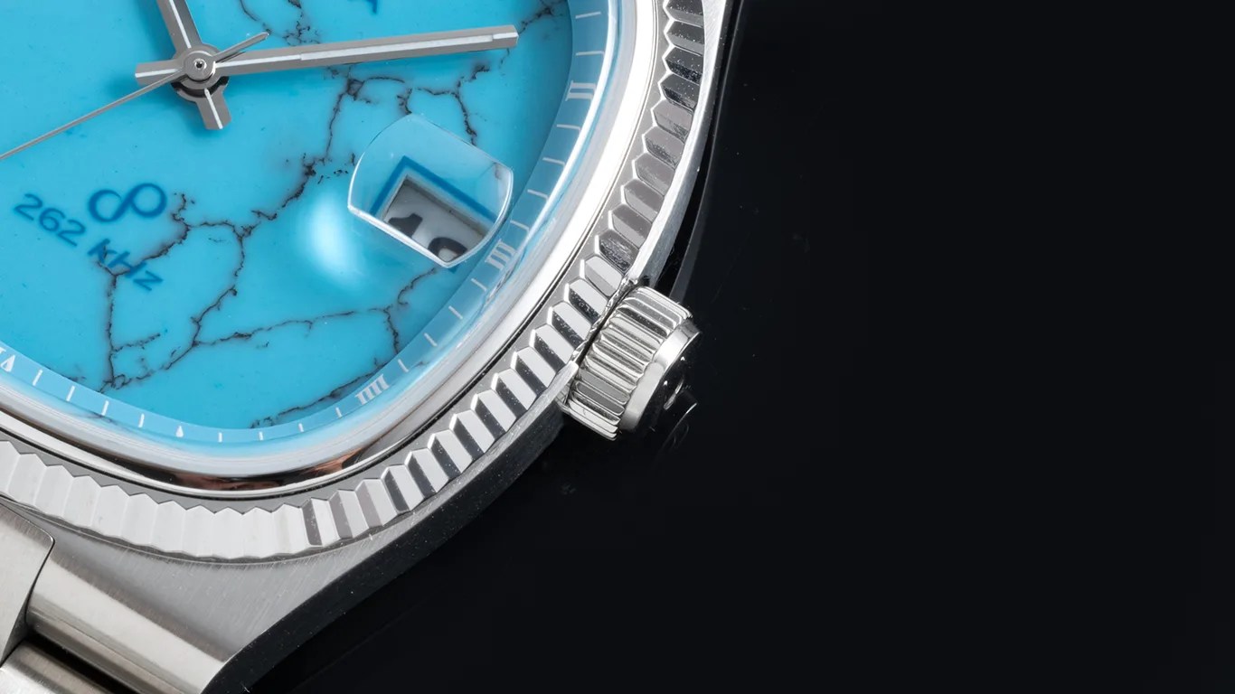 a closeup of a bulova watch with a stone dial