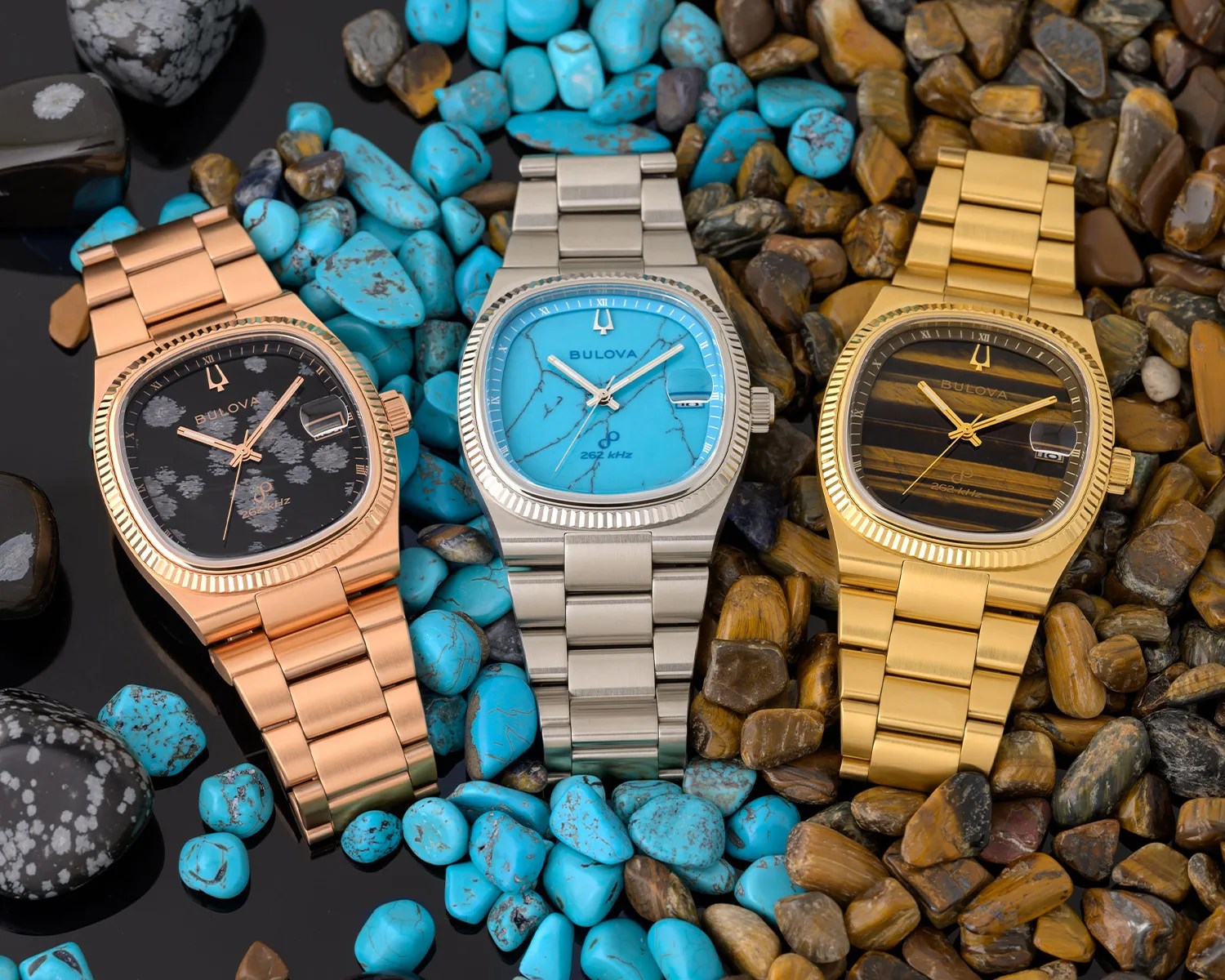 three bulova watches with stone dials on a pile of stones