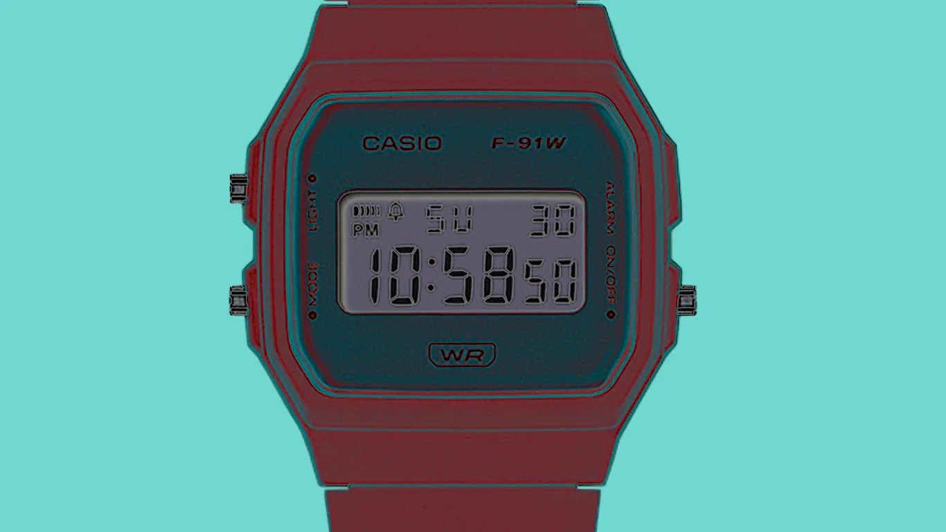 a casio watch with its colors inverted against a tiffany blue background
