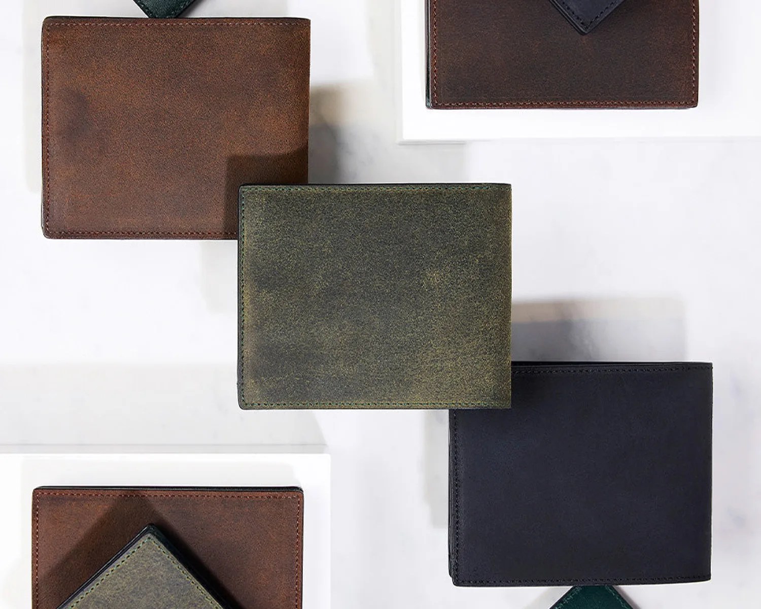an assortment of Crockett and Jones leather wallets