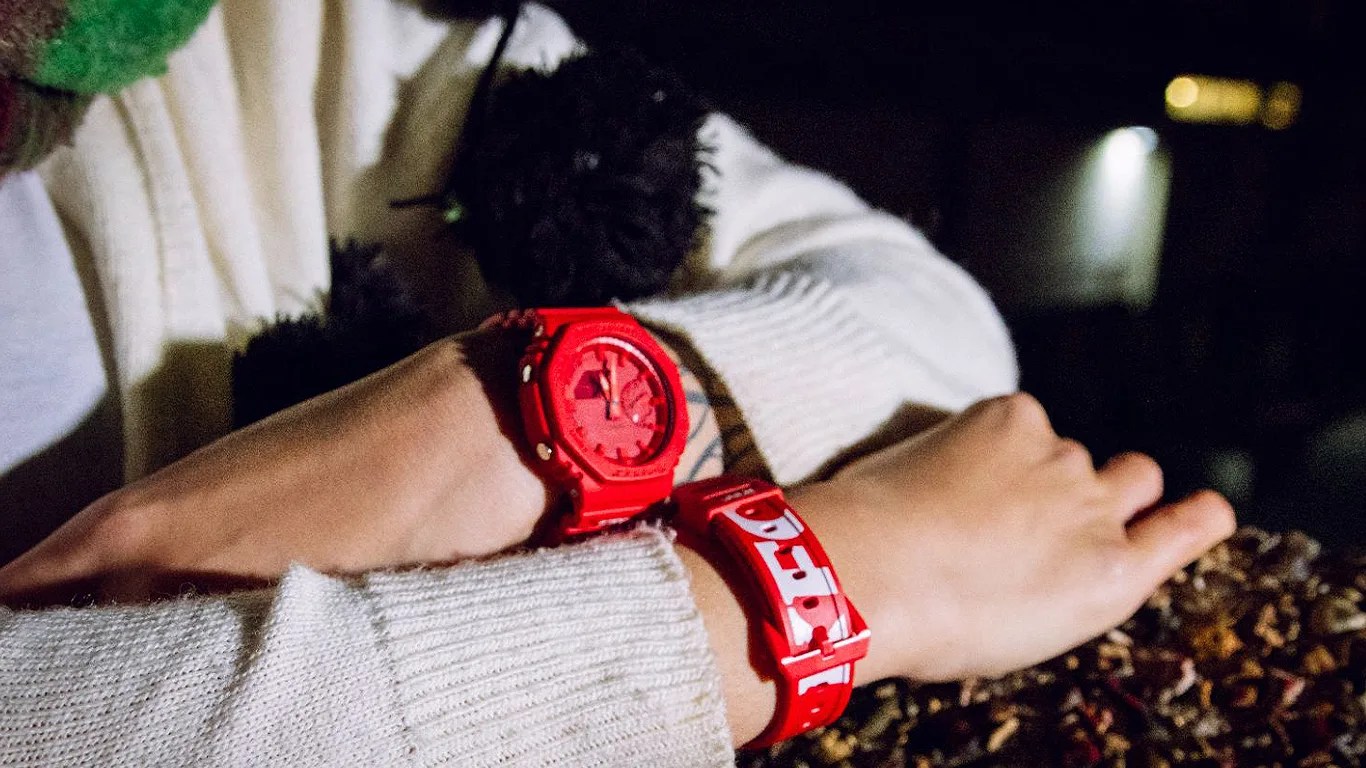 a person wears two red g shock watches