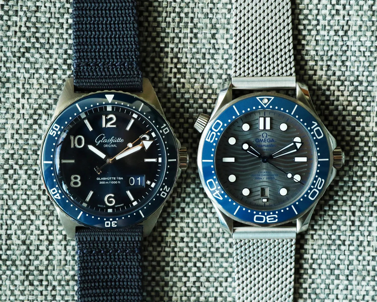 a glashutte original dive watch next to an omega seamaster dive watch