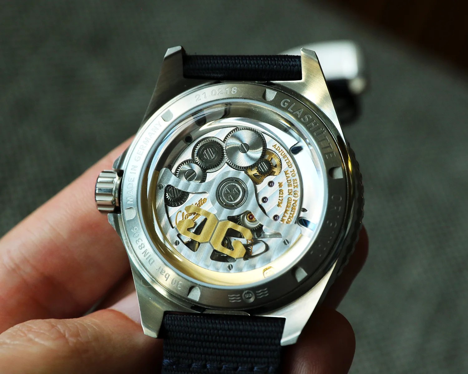 the automatic movement of a glashutte original dive watch seen through a display caseback