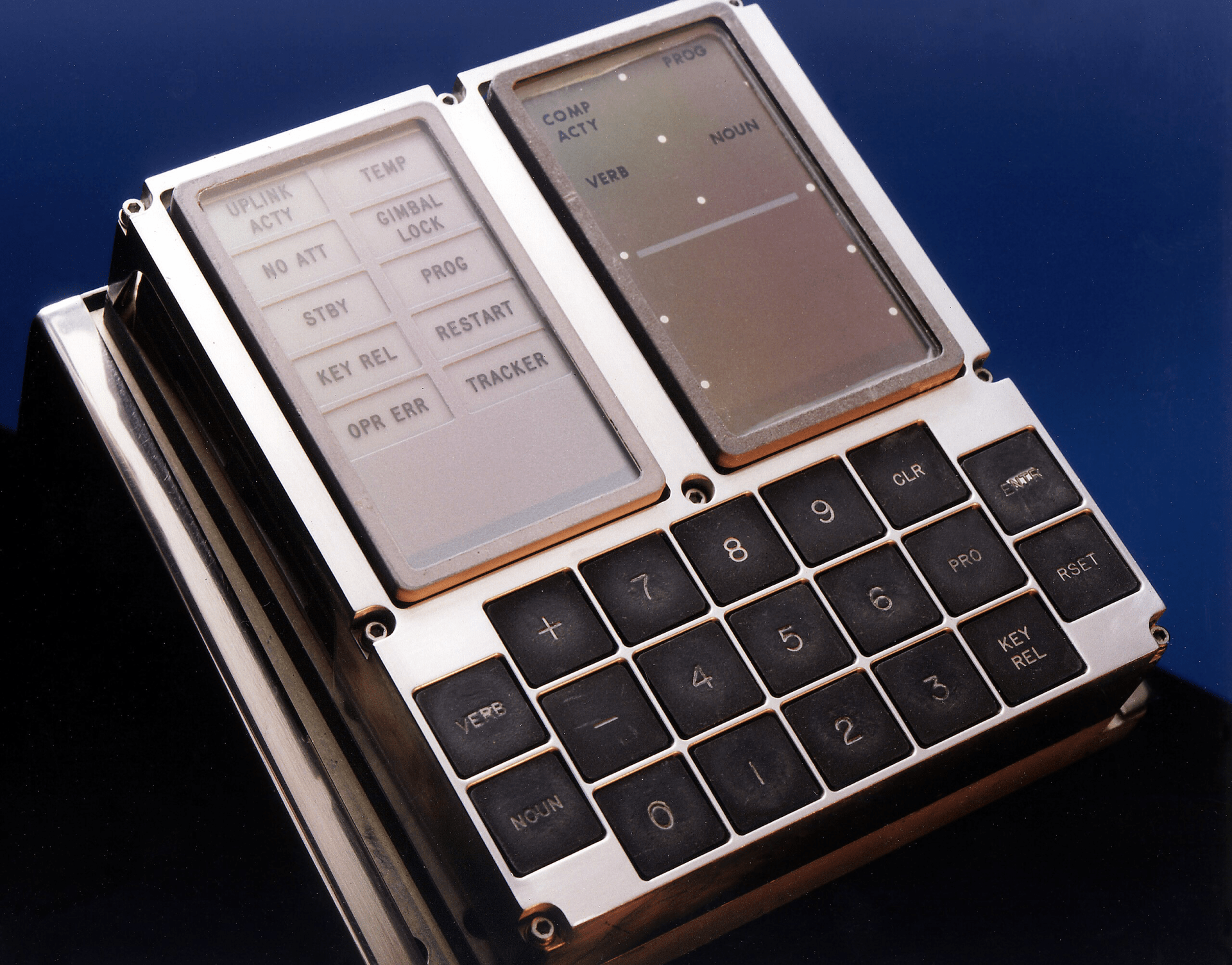 The display and keyboard (DSKY) unit used on the F-8 Digital Fly-By-Wire (DFBW) aircraft during Phase I of the fly-by-wire program. The piece of spacecraft equipment is shown by itself laying flat against a dark blue background.