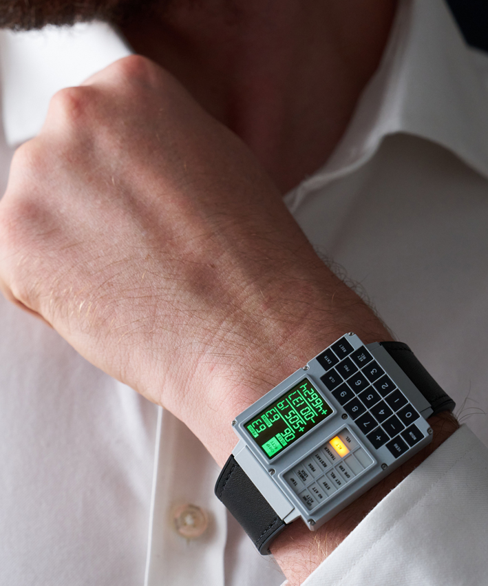 The Apollo Instruments DSKY Moonwatch shown being worn on a mans wrist. The wrist is held up to show the watch. In the background is the wearer's white dress shirt. 