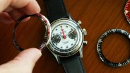 a hand holds a bezel above a nivada chronograph watch