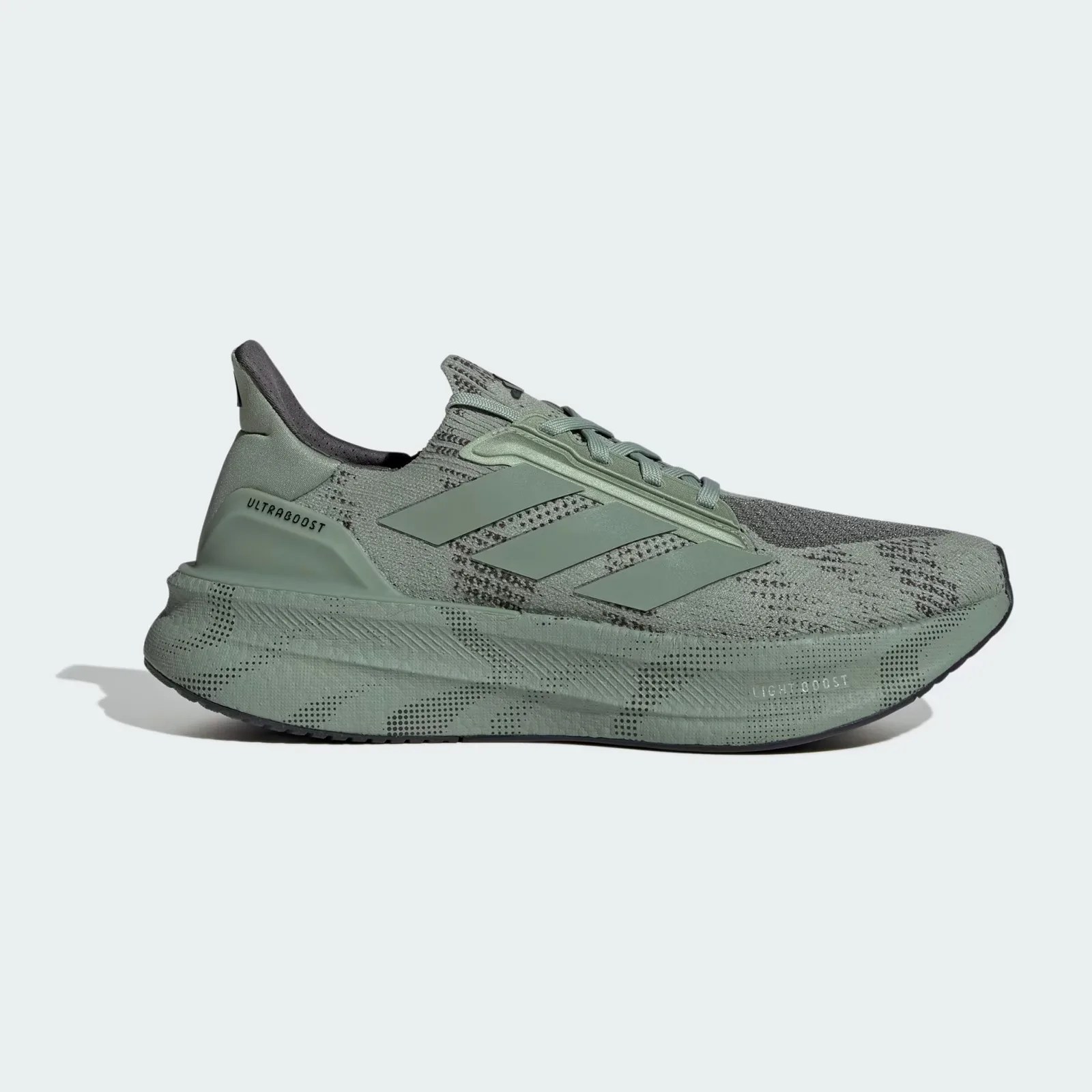 A single Adidas Ultraboost 5X shoe in silver green shown in profile to reveal the inside edge of the sneaker. 
