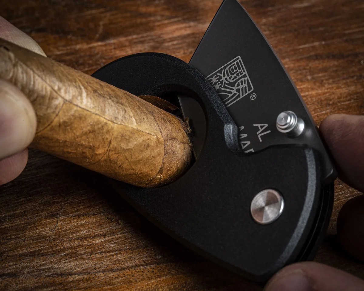 Closeup of Al Mar Havana Clipper Cigar Cutter cutting a cigar