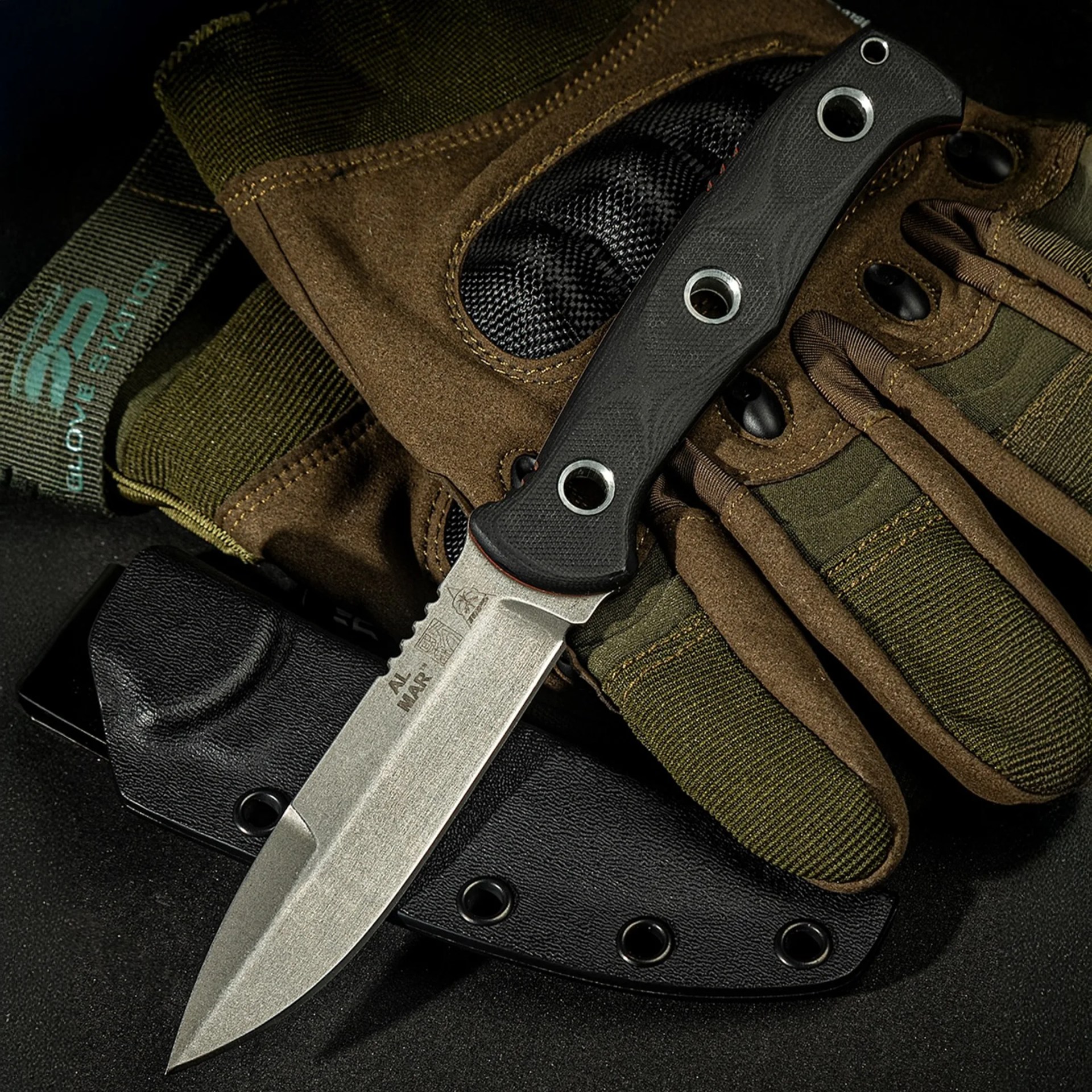 Al Mar x Tops SERE Operator knife laying on tactical gloves and sheath