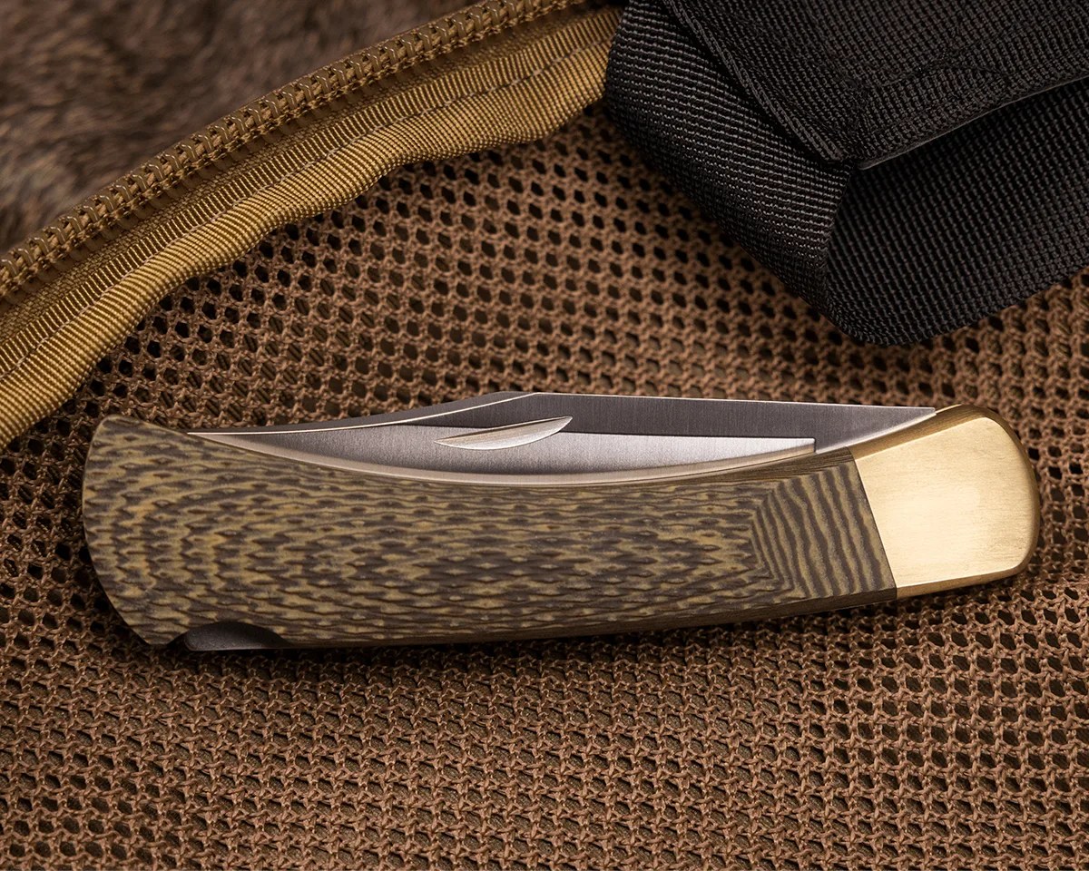 Closed Buck 110 Folding Hunter knife on tan mesh bag