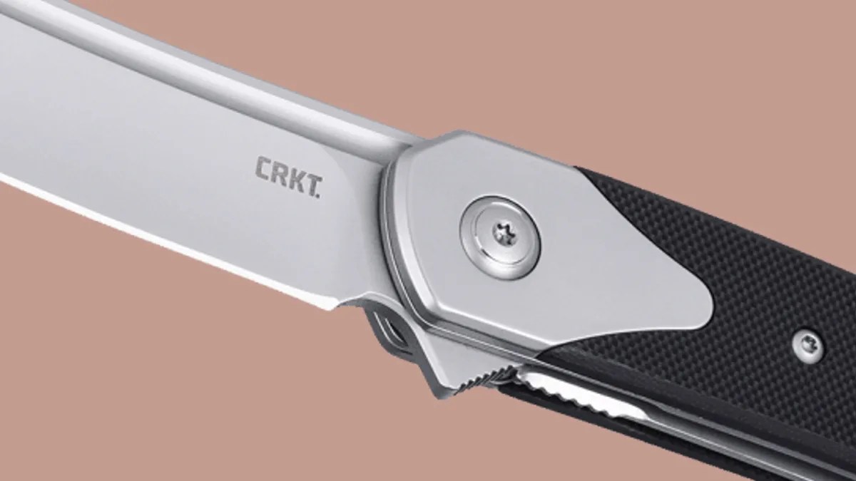 CRKT Viento knife closeup of pivot on pink background
