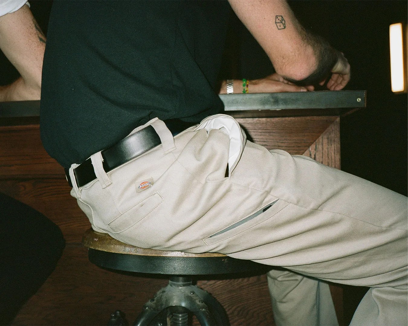 man wearing dickies pants sitting at table
