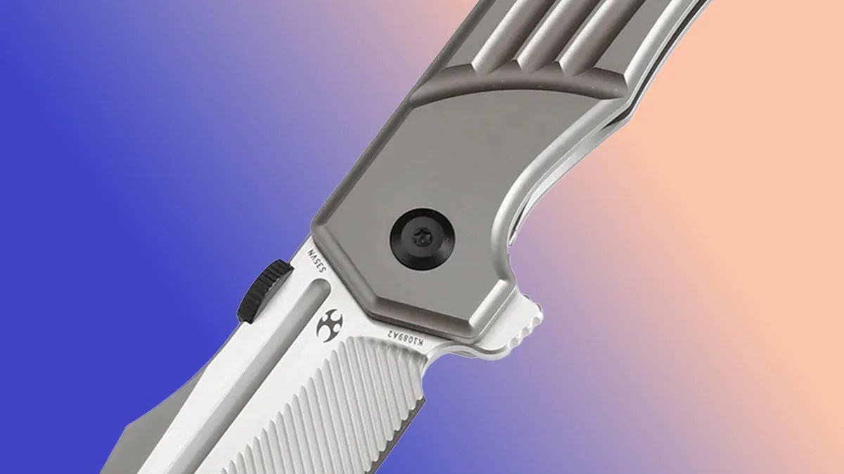 Closeup of Kansept Orion knife on blue-pink background
