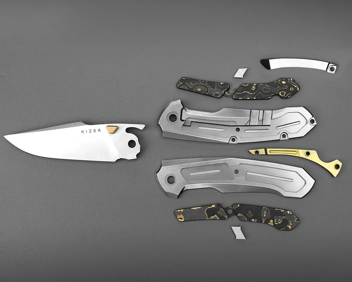 Kizer Feweed knife taken apart on gray background
