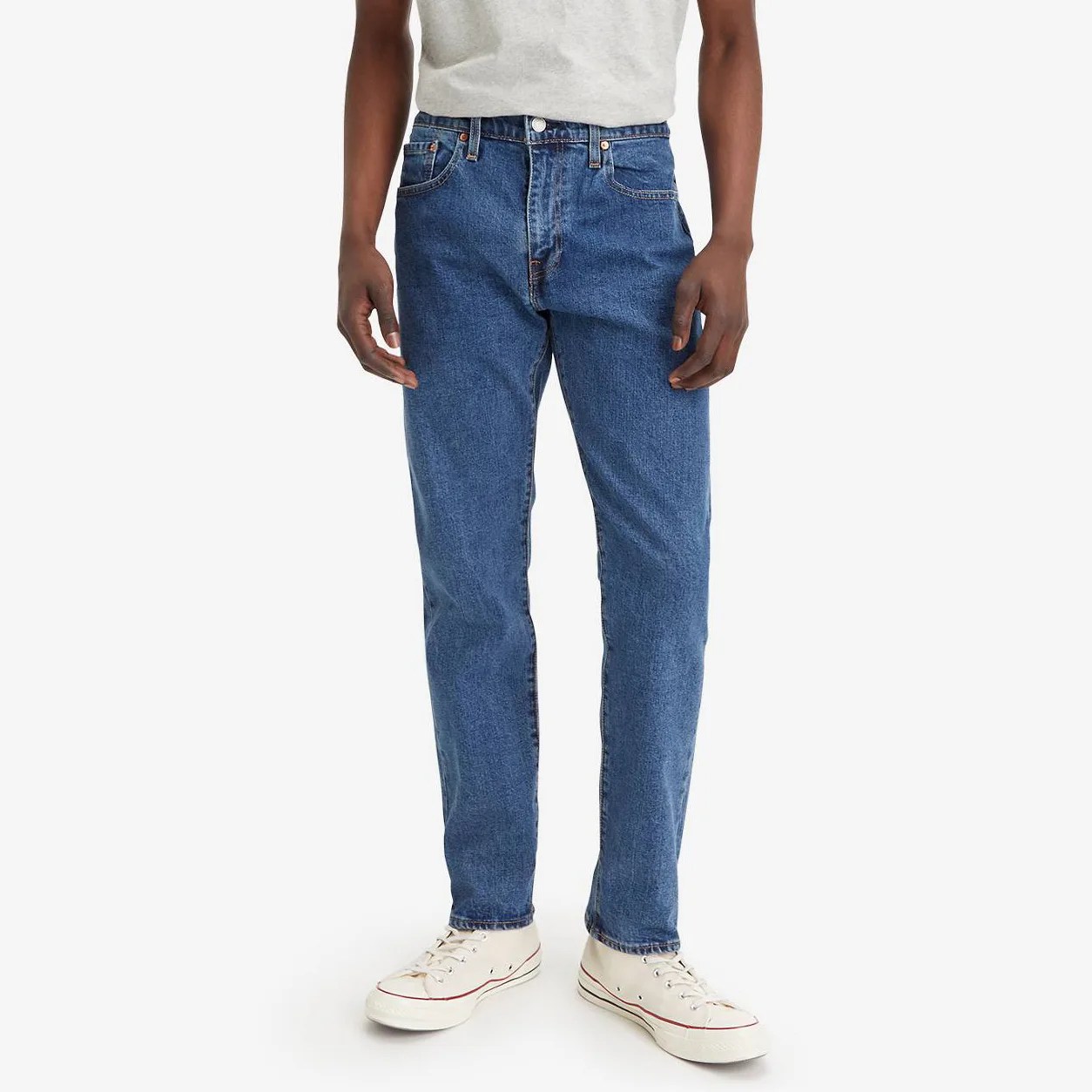 A man in jeans, from the waist down.