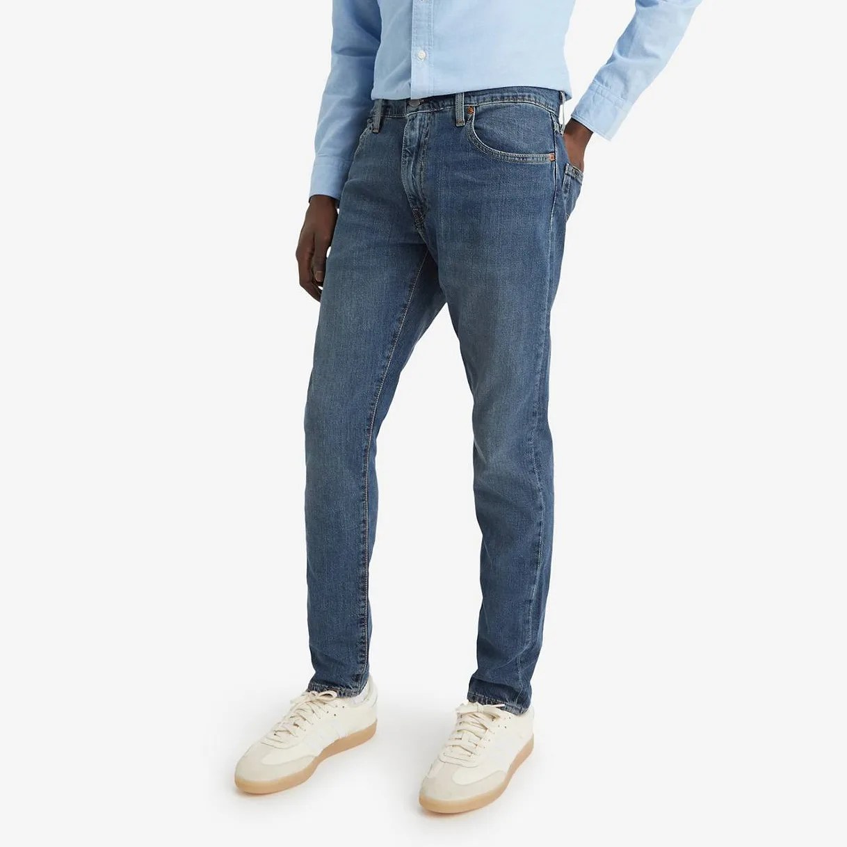 A man in jeans, from the waist down.
