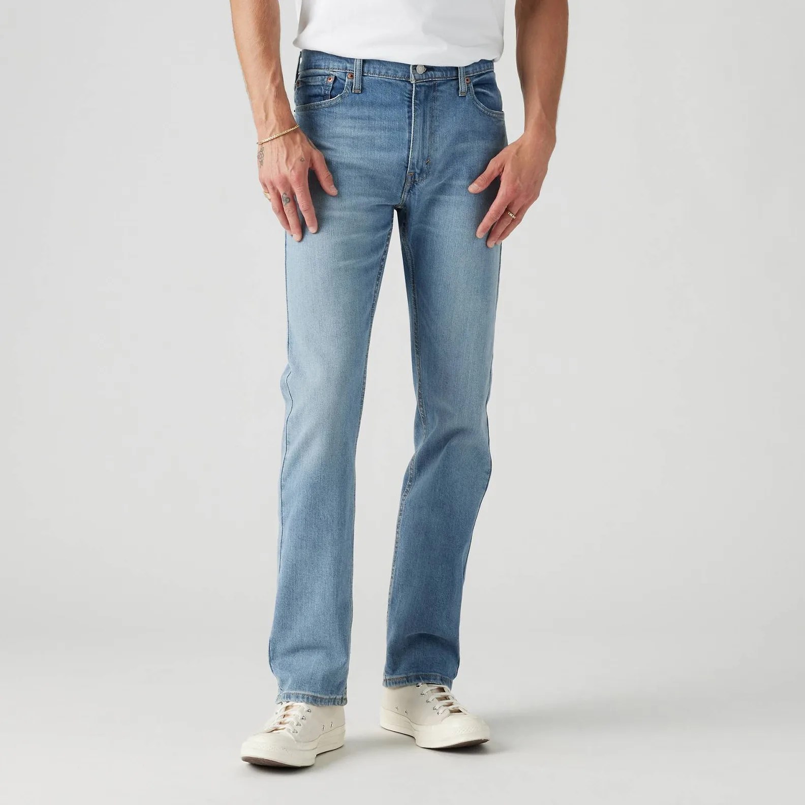 A man in jeans, from the waist down.
