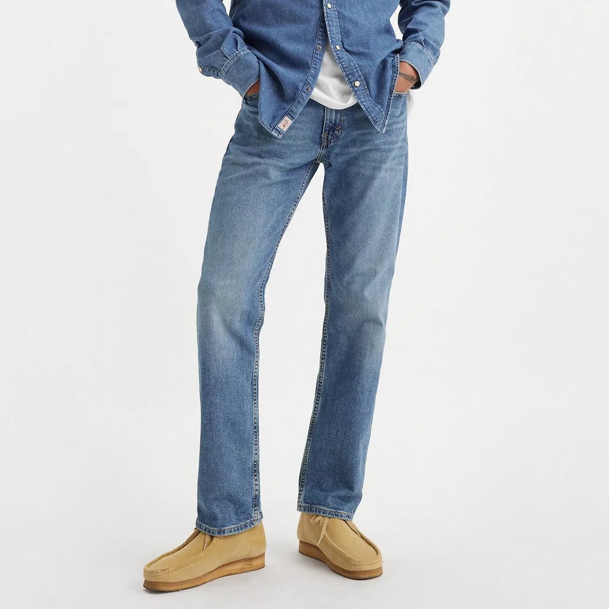 A man in jeans, from the waist down.