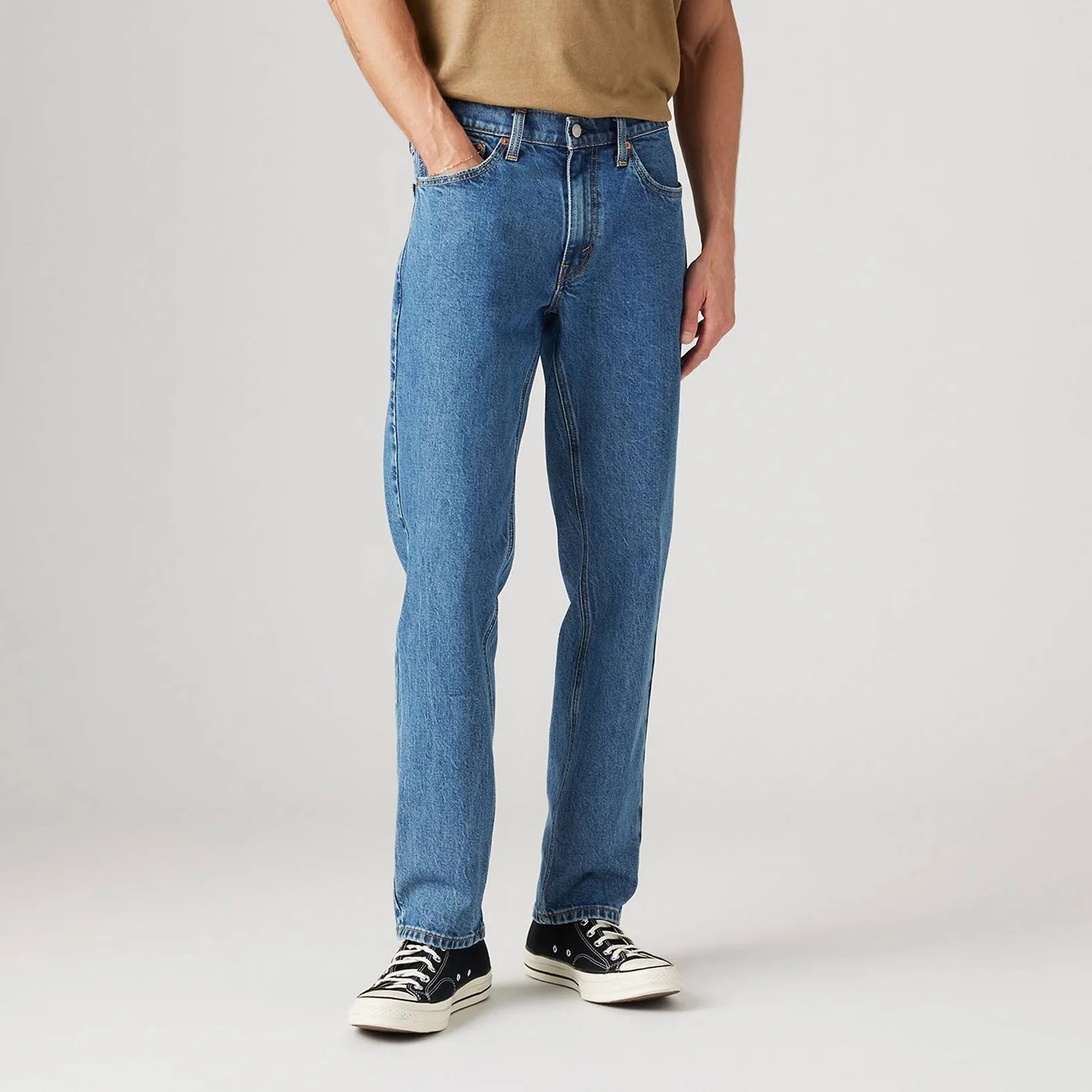A man in jeans, from the waist down.