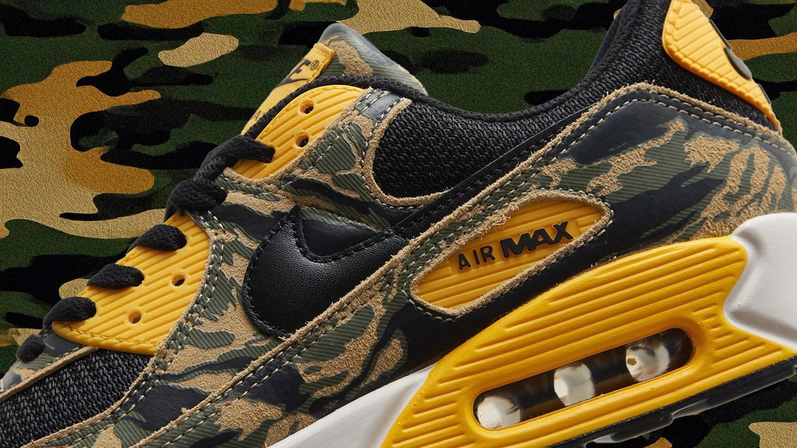 A detailed shot of Nike Air Max 90 in yellow and camo against a camo background