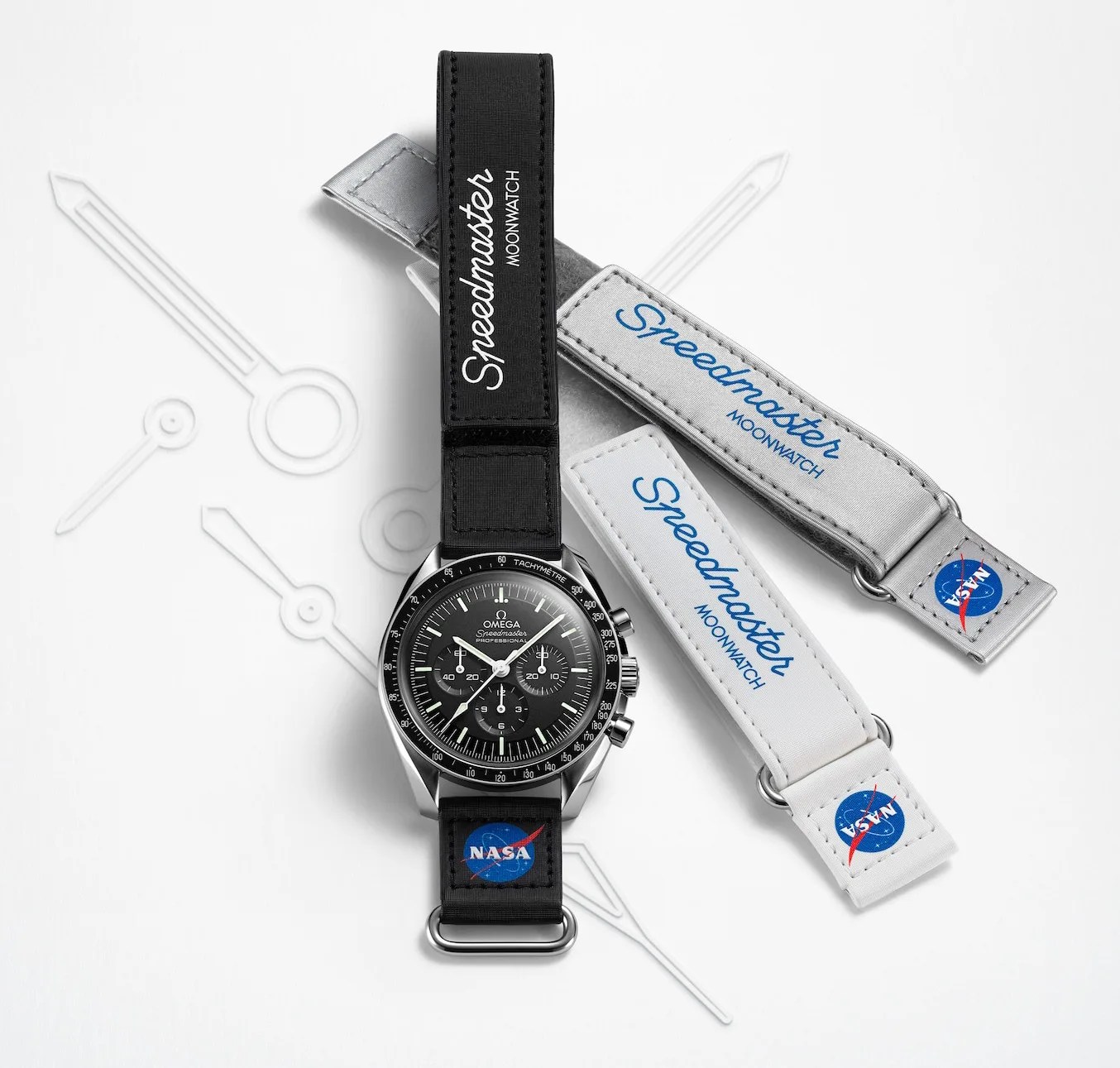 Omega two piece velcro strap for the Omega Speedmaster with Nasa logos in black attached to an Omega Speedmaster watch. Two other version of the strap in silver and white are also shown separately beside the watch. 