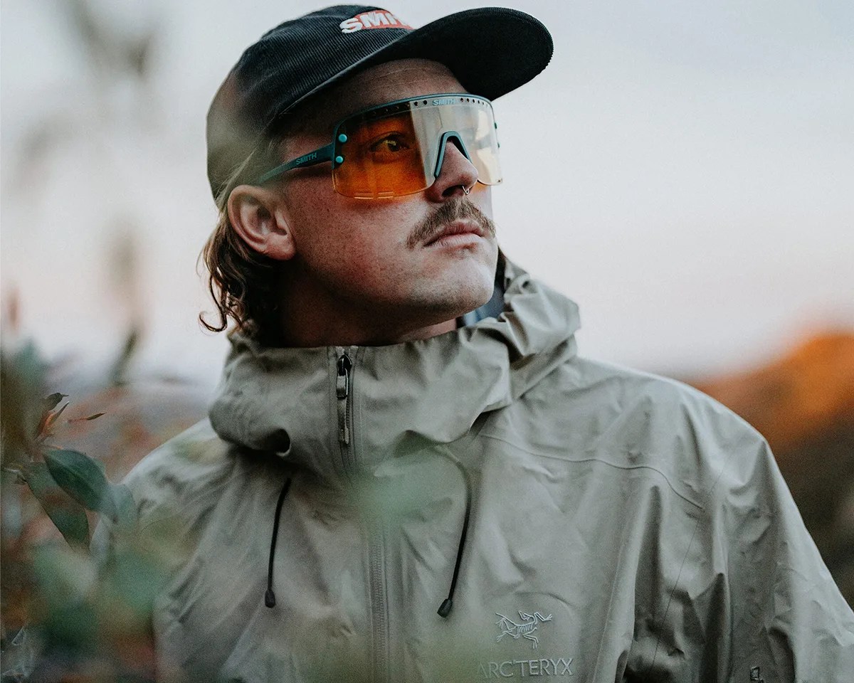 Mustached man in Arc'teryx jacket and Smith hat wearing Smith Ultralight sunglasses