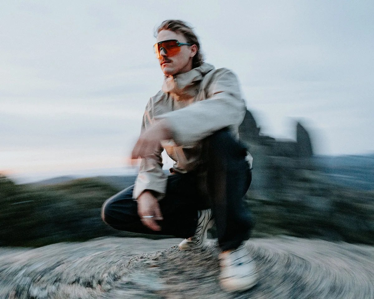 Blurry photo of mustached man in Arc'teryx jacket wearing Smith Ultralight sunglasses outdoors