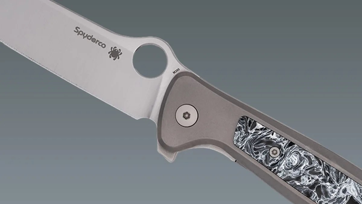 Closeup of Spyderco Slym knife on gray gradient background