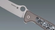 Closeup of Spyderco Slym knife on gray gradient background