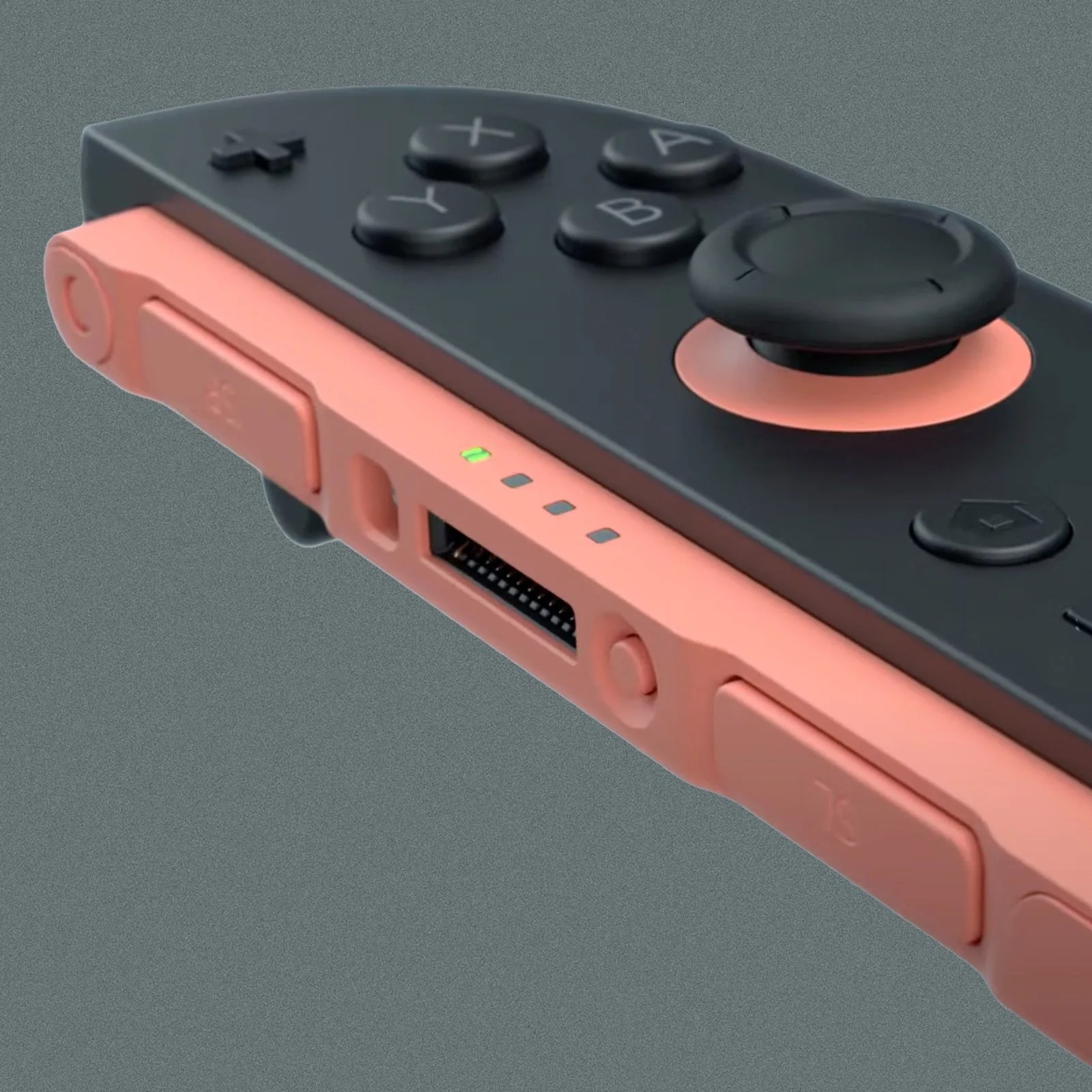 A close up image of the Switch 2 right side Joy-Con controller shown separated and own its own. The controller is black with pink details under the analog stick and along the back edge. The photo highlights a new mysterious button. 