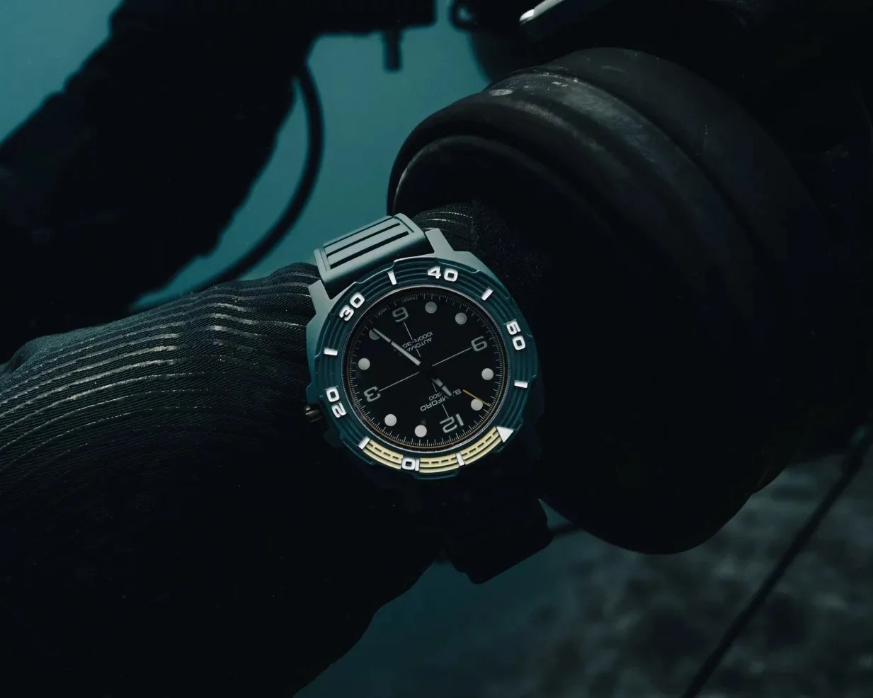 A dive watch on a scuba diver's wrist