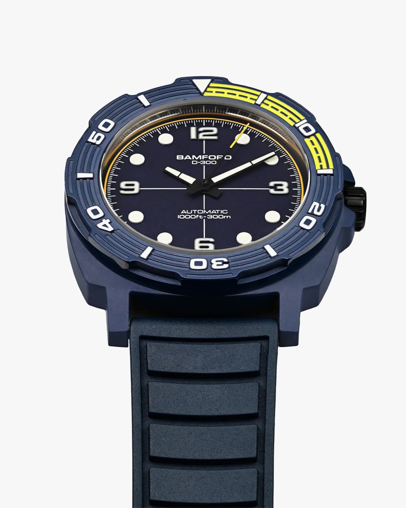 The dial, crown and case of a blue dive watch
