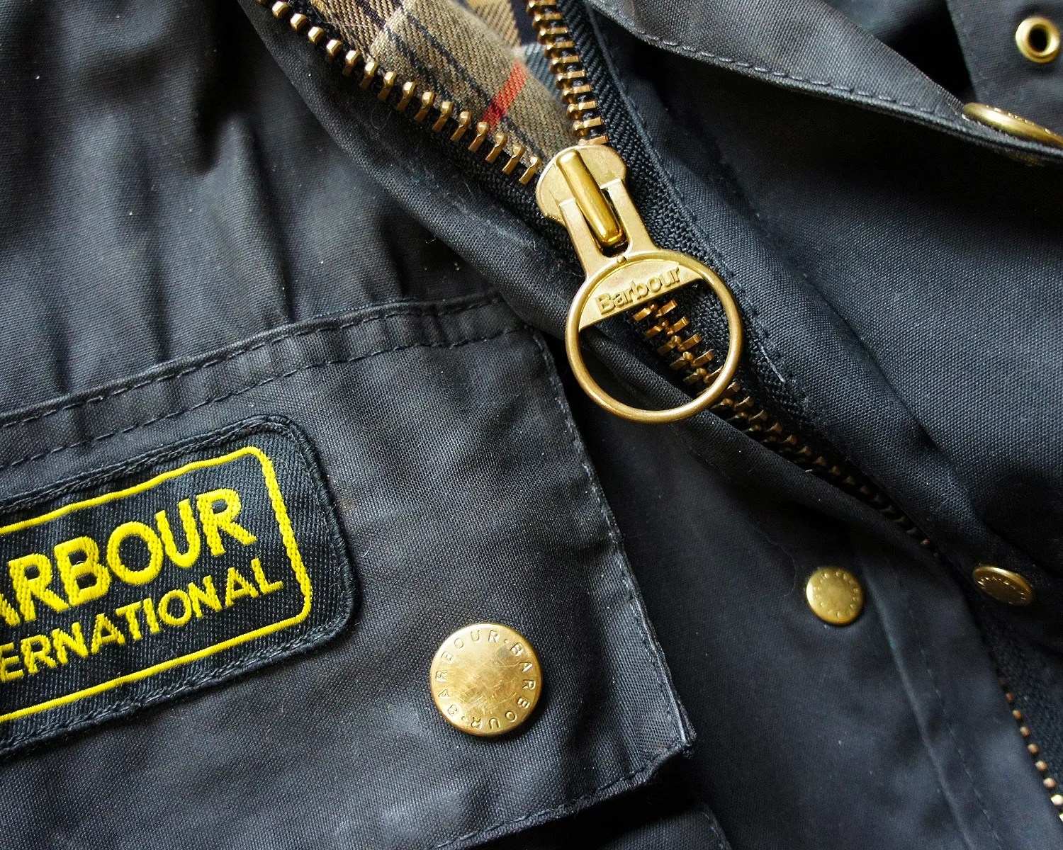 a closeup of a barbour jacket zipper