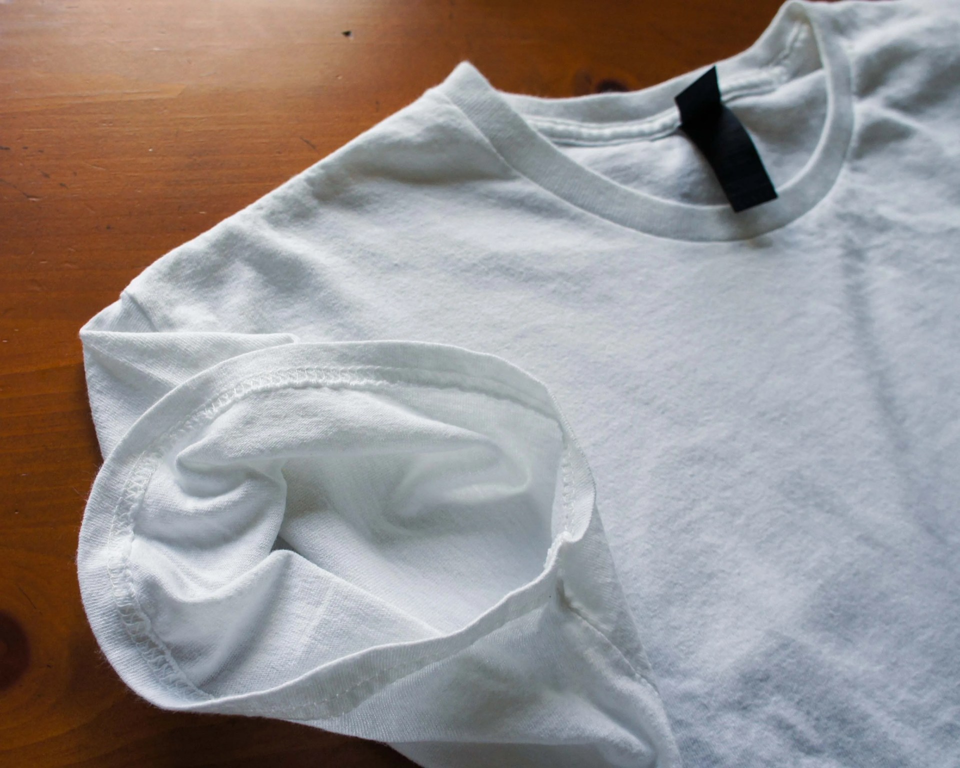 close up of the seam stitching on a white t-shirt