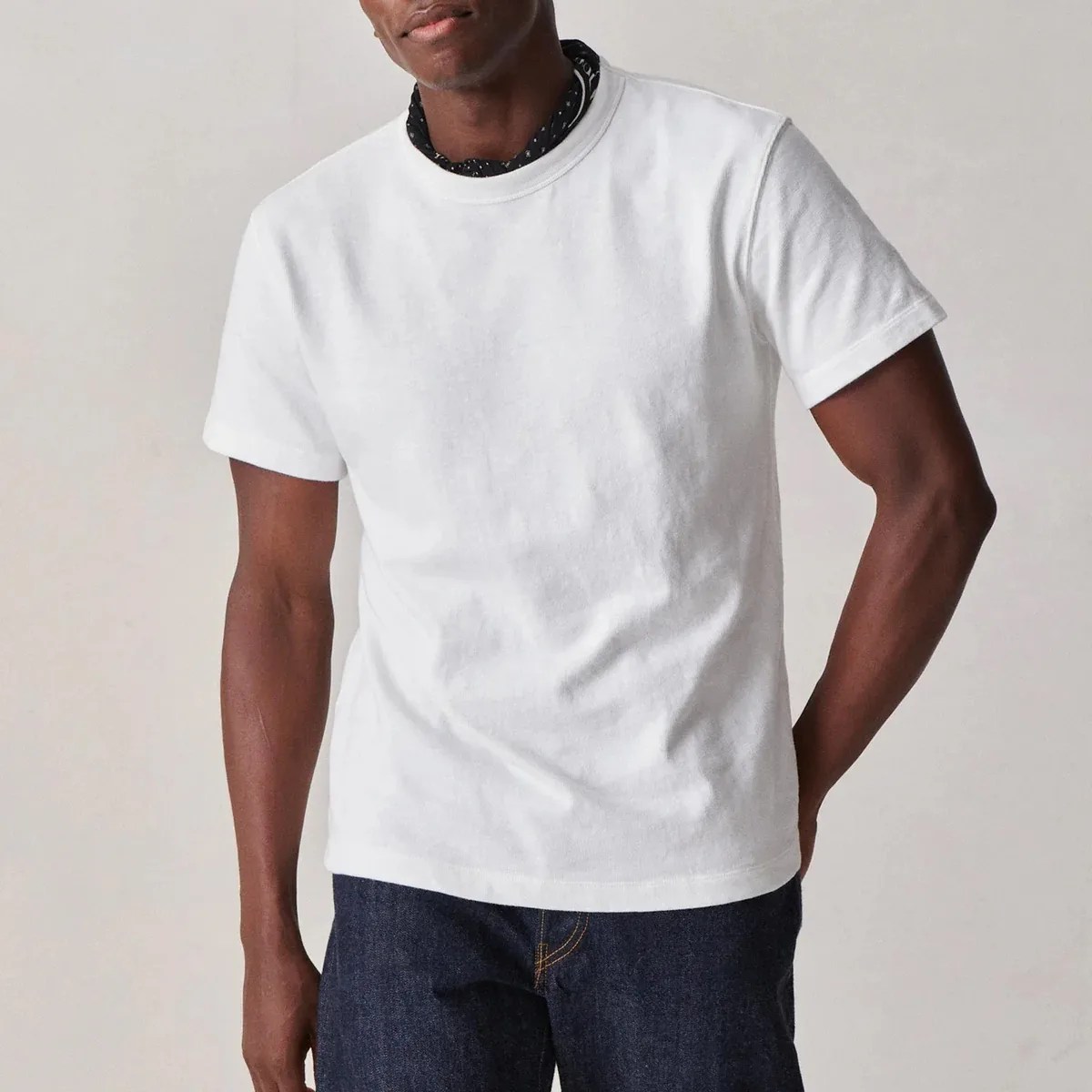 A man in a white t-shirt and jeans