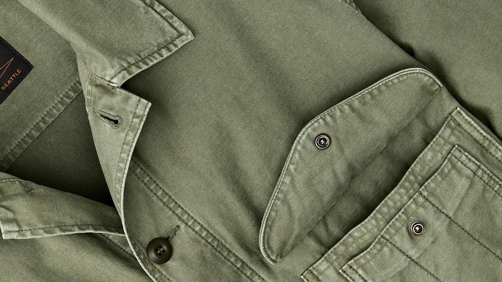 the open chest pocket and collar of a green Filson Field Cruiser Jacket