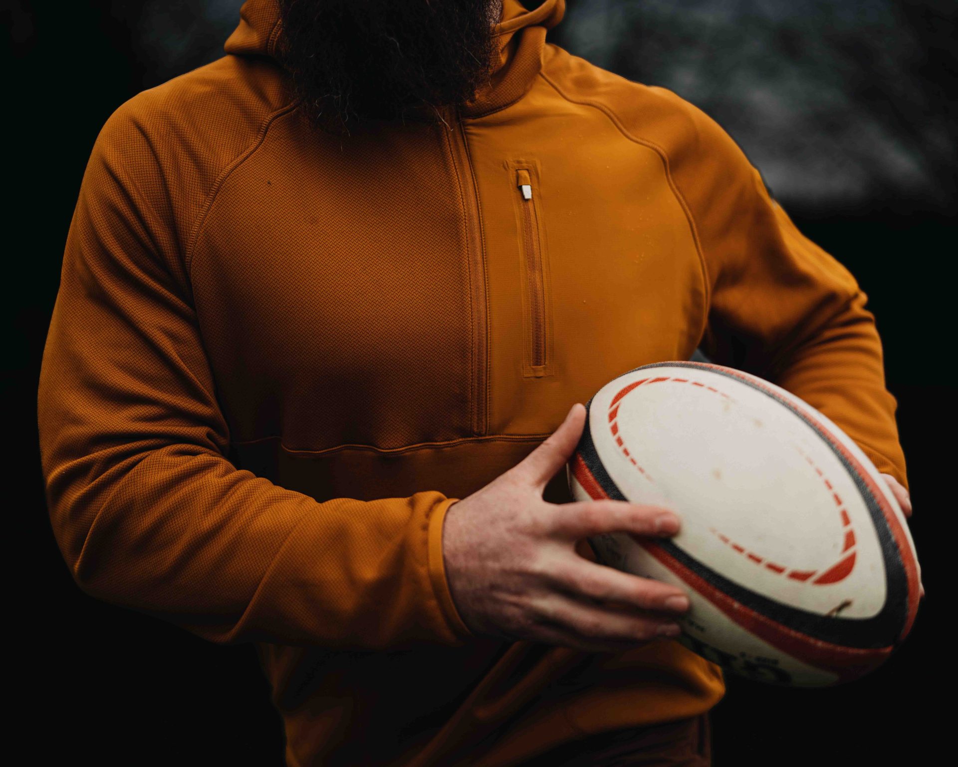 A guy in a hoodie with a ball