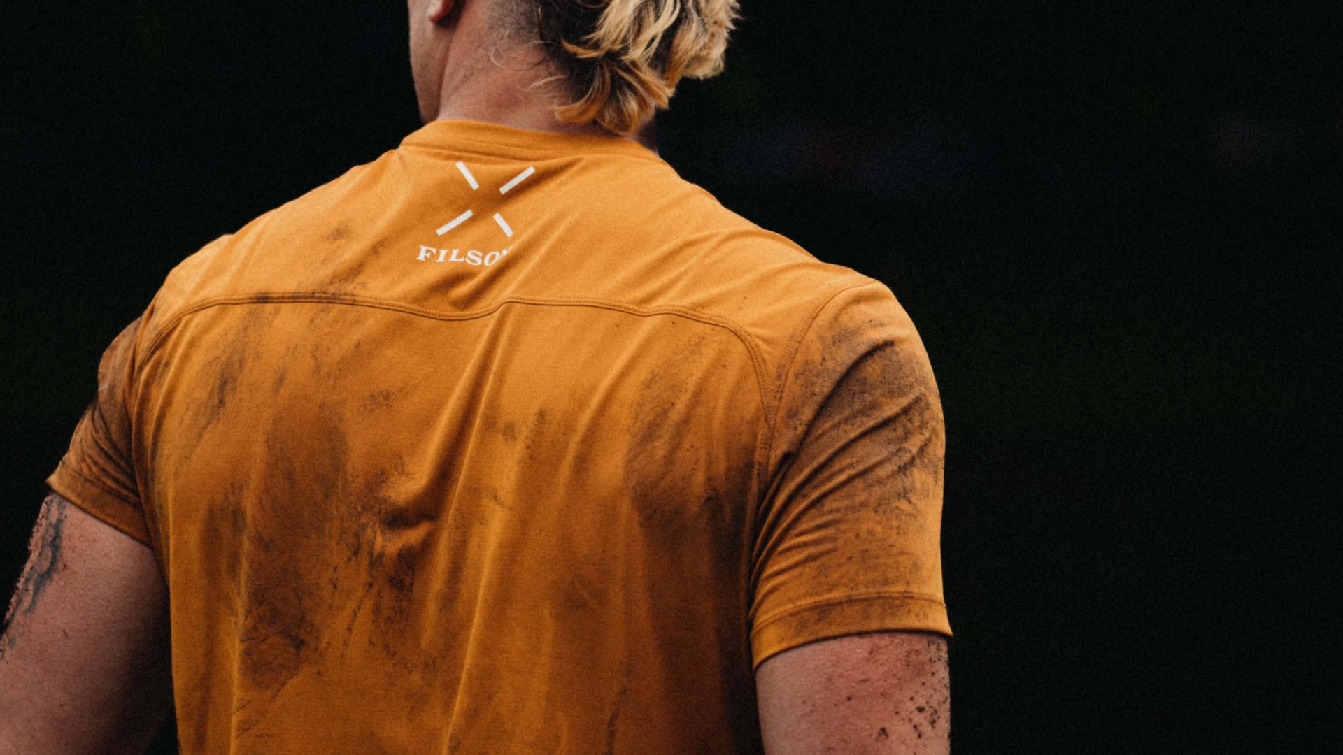 Back of a guy in a yellow t-shirt